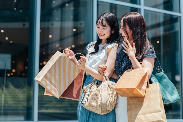 ブランディングされたブランド物を買って歩いている女性二人